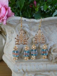 Very stunning..gold plated chatons with pale blue glass on a filigree mount. Price: &pound;29.96